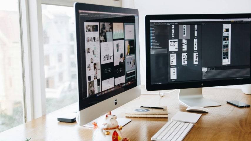 Brand Your Business A set of two monitors displaying branding elements in design.